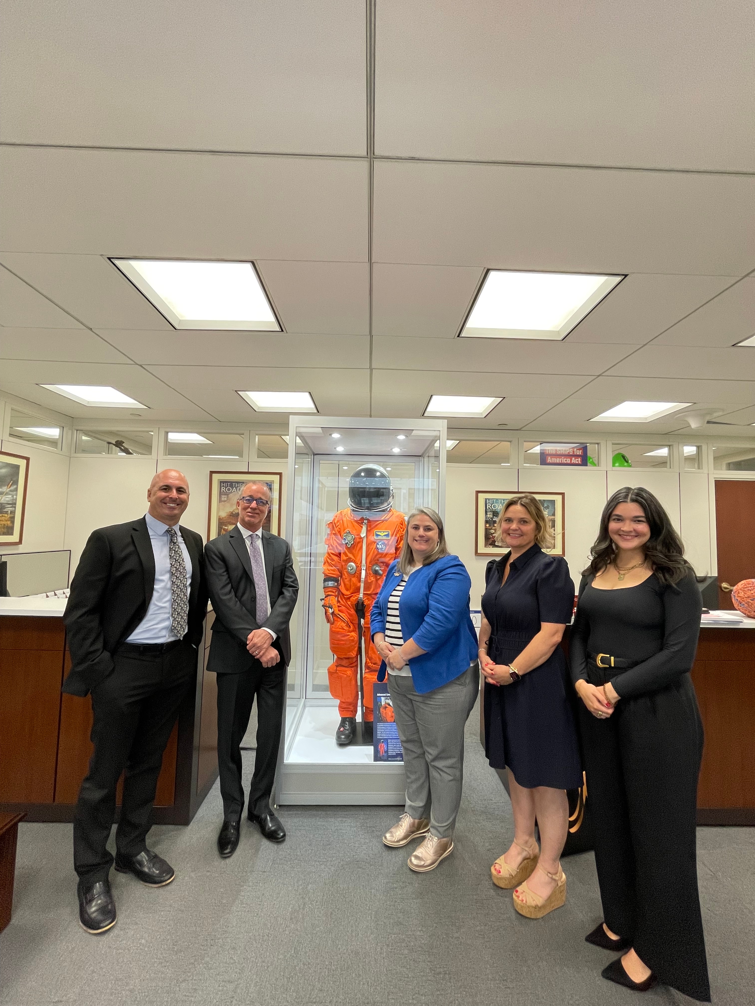 There are five people in front of the camera